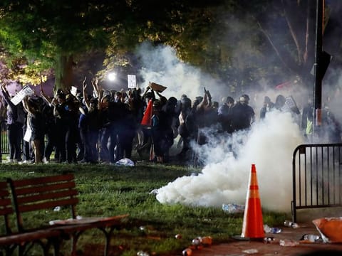 Tear gas billows as demonstrators gather in Lafayette Park to protest the death of George Floyd, Sunday, May 31, 2020, near the White House in Washington.