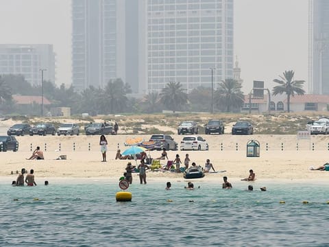 People soak up the sun and enjoy swimming at one of the beches in Dubai. Official statistics show that incidents of drowning while swimming in the sea have declined over the past one year.