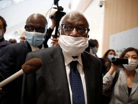 Lamine Diack, former President of the International Association of Athletics Federations (IAAF), wearing a face mask, arrives for his trial at the Paris courthouse on Monday.