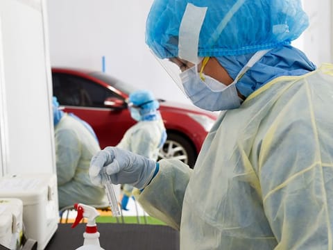 A paramedic staff collects swab samples at a coronavirus drive-through screening center by Dubai Health Authority at Al Nasr Club in Dubai. Photo for illustrative purpose only.  
