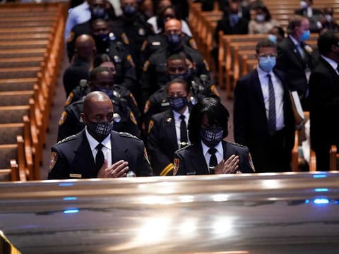 Members of the Texas South University police department pause by the casket of George Floyd during a funeral service at the Fountain of Praise church, in Houston, Texas, U.S., June 9, 2020. 