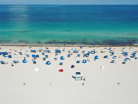 An aerial drone view as beachgoers take advantage of the opening of South Beach on June 10, 2020 in Miami Beach, Florida.
