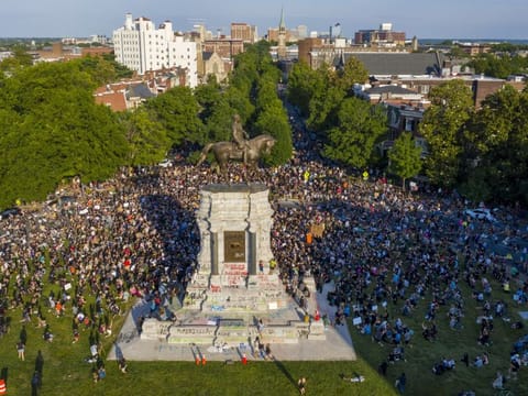 This Tuesday, June 2, 2020 file photo shows a large group of protesters gather around the statue of Confederate General Robert E. Lee on Monument Avenue near downtown in Richmond, Va. Virginia Gov. Ralph Northam announced plans Thursday, June 4, for the removal of the iconic statue. 