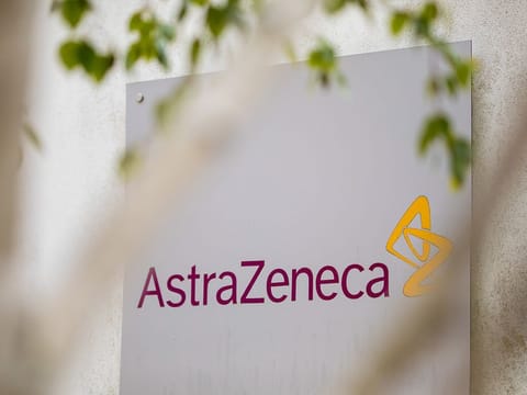 A sign featuring the AstraZeneca Plc logo stands at the company's DaVinci building at the Melbourn Science Park in Cambridge, UK. 