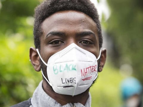 William Ngugi walks with others during a Black Lives Matter of Seattle-King County silent march on June 12, 2020 in Seattle, Washington, US. 