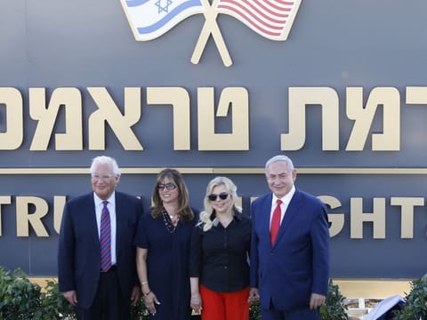 This June 16, 2019 picture shows Israeli Prime Minister Benjamin Netanyahu, right, his wife Sara , United States Ambassador to Israel David Friedman, left, his wife Tammy pose during the inauguration of a new colony named after President Donald Trump in the Golan Heights.
