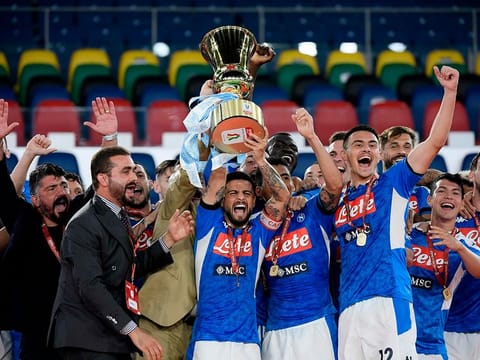 Napoli’s Lorenzo Insigne (C holding trophy), head coach Gennaro Gattuso (L) and players celebrate after winning the Coppa Italia final.