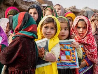 Afghan refugee children stand outside a school in Islamabad, Pakistan, home to around 3,000 Afghan refugees. Image Credit -  UNHCRRoger Arnold