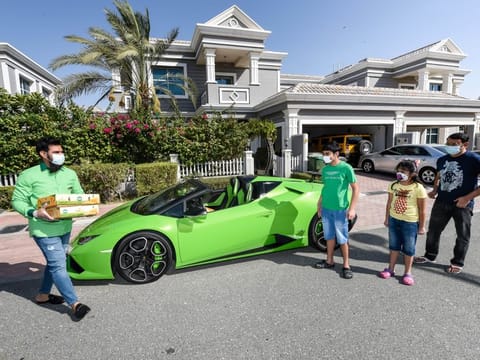 Muhammad Jehanzeb, managing director of Pakistan Supermarket delivering the mangoes at the residence of  Arshad Khan and kids Ayaan and Aiza in Lamborghini. 
