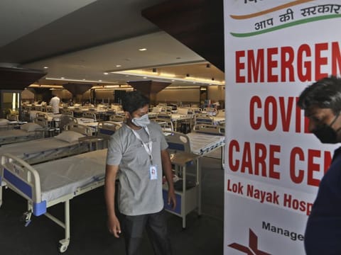Health workers walk across a COVID-19 care centre being set up in New Delhi, India Tuesday, June 23, 2020. While India’s leaders have promised coronavirus testing and care for all who need it, regardless of income, treatment options are as stratified and unequal as the country itself. Care ranges from crowded wards at public hospitals that some worry will make them sicker than if they stayed home to spacious suites at private hospitals that only the wealthy can afford. 