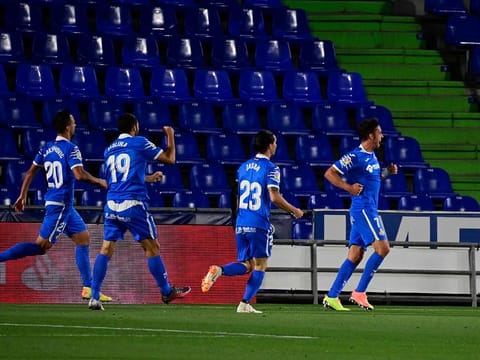 Getafe's Spanish forward Jaime Mata (R) celebrates after scoring.