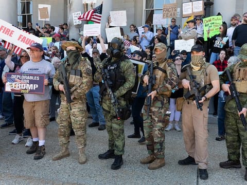 people, including those with the boogaloo movement, demonstrate against business closures due to concern about COVID-19, at the State House in Concord, New Hampshire.