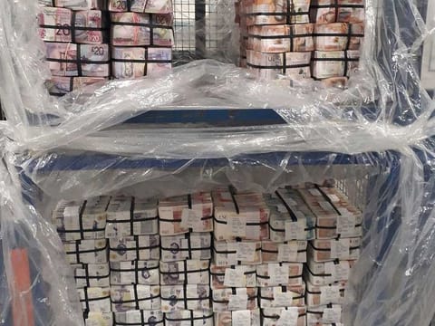 In this photo issued Thursday July 2, 2020, by the London Metropolitan Police showing cash worth 5.1 million pounds, seized in Operation Venetic, an investigation on Encrochat, a military-grade encrypted communication system used by organised criminals trading in drugs and guns.  According to information released by police authorities, officers in the UK had arrested 307 suspects, recovered 106 Encrochat devices and seized many millions in currency, with many thousands of officers involved in a massive international sting.