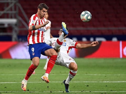 Atletico Madrid's Spanish forward Alvaro Morata (left) is challenged by Real Mallorca's Serbian defender Aleksandar Sedlar during the Spanish League match in Madrid on Friday.