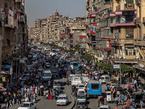 In this April 14, 2020 file photo, people crowd a street a few hours ahead of curfew in Cairo, Egypt.