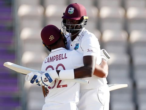 West Indies captain Jason Holder, right, hugs teammate John Campbell after their win on the fifth day of the first cricket Test match between England and West Indies, at the Ageas Bowl in Southampton, England, Sunday, July 12, 2020. 