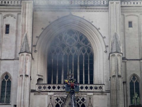 Fire fighters brigade work to extinguish the blaze at the Gothic St. Peter and St. Paul Cathedral, in Nantes, western France, Saturday, July 18, 2020. 