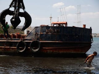 Photos: Greece's great declutter at battle coastline