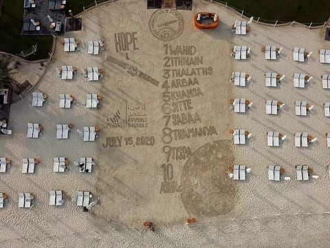 A drone-shot of Dubai-based Filipino sand artist Nathaniel Alapide, making an artistic send-off piece to the Hope Probe on the sands of the Dubai beach at Rixos Premium Dubai in JBR last Tuesday. 