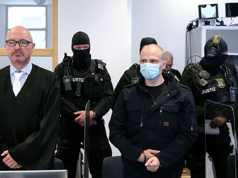 Accused Stephan Balliet, right stands next to his lawyers Hans-Dieter Weber, in the courtroom of the regional court at the beginning of the trial in Magdeburg, Germany, Tuesday, July 21, 2020. 