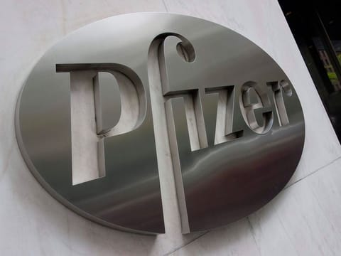 Pfizer report profits of $4.5 billion compared with a loss of $2.4 billion in the year-ago period.