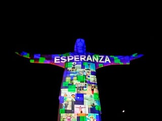 Images of essential workers projected on Cristo Rey monument