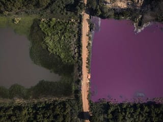 Pollution turns one side of divided Paraguayan lagoon purple