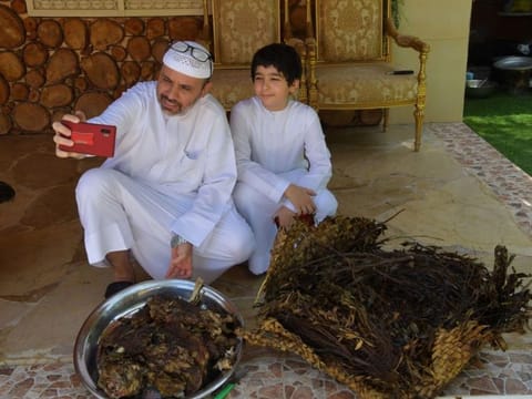 Sultan bin Mejren and his son  get ready for the tanoor