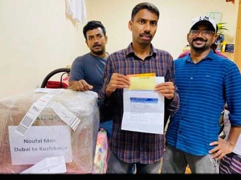 Indian expat Noufal Moin (centre) with his friends after he was off-loaded from the ill-fate Air India Express flight due to non-payment of visa fine. 