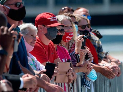 Supporters listen to US President Donald Trump's remarks on economic prosperity, at Burke Lakefront Airport in Cleveland, Ohio, on August 6, 2020. 