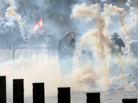 Riot police fire tear gas at demonstrators during a protest on August 8, 2020, following Tuesday's blast, in Beirut, Lebanon. 