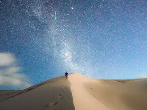 A starry night sky in the desert.