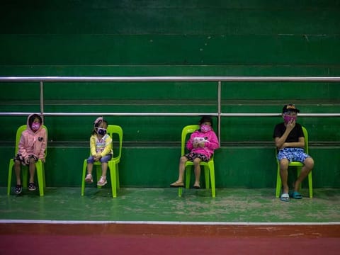 Children queue for a free COVID-19 swab testing at a gymnasium in Navotas City, Metro Manila.