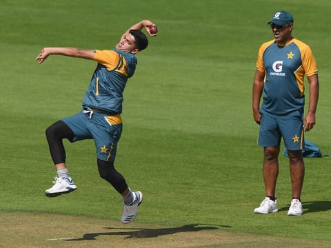 Pakistan's bowling coach Waqar Younis, right, watches Naseem Shah bowl to warm up, at the Ageas Bowl in Southampton. 