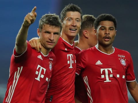 Bayern's Serge Gnabry, right, celebrates his side's second goal with teammates Robert Lewandowski, center, and Thomas Mueller.