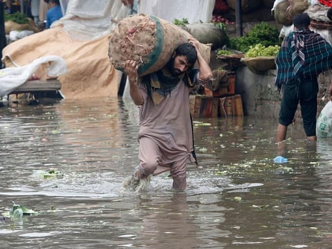 File image used for illustrative purposes: A laborer carries sack of onion while wades through a flooded area after heavy rainfall in Lahore, Pakistan, Thursday, Aug. 20, 2020. 