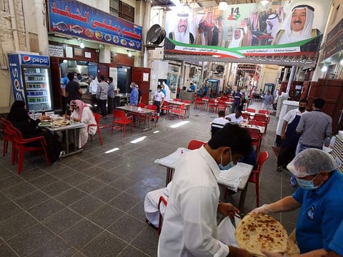 People have lunch at a restaurant in Kuwait City.