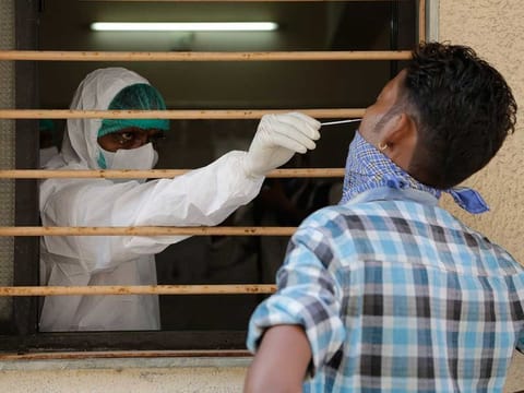 A health worker takes a nasal swab sample to test for COVID-19 at an urban health centre in Ahmedabad, India, Thursday, Sept. 10, 2020. 