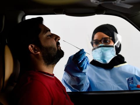 Paramedics taking swab sample at the SEHA drive through National Screening Center at Golf and Shooting club in Sharjah  Photo: Virendra Saklani/Gulf News