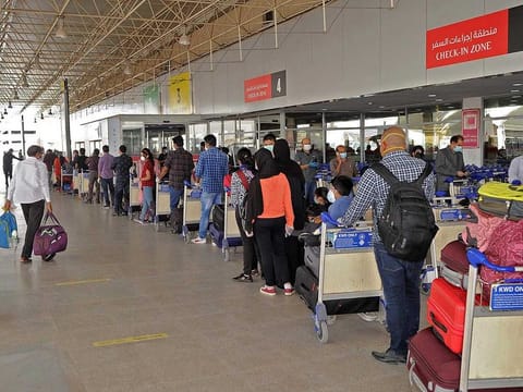 In this file photo taken on May 09, 2020 Indian citizens queue up at Kuwait International Airport before boarding a repatriation flight to India, in Kuwait City. 