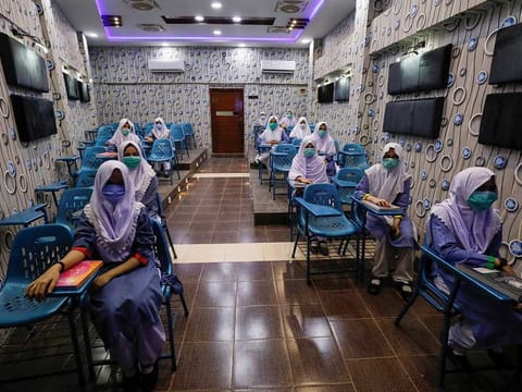 Students keep safe distance while attending an audio-visual class, as schools reopen amid the coronavirus disease (COVID-19) pandemic, in Karachi, Pakistan September 15, 2020.