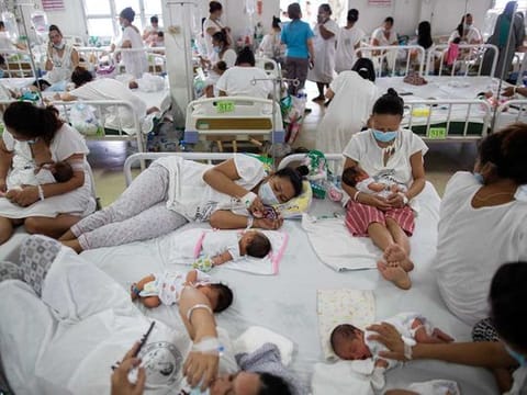 Mothers wearing masks rest with their newborn babies on shared beds inside the maternity ward of the government-run Dr. Jose Fabella Memorial Hospital, amid the coronavirus disease (COVID-19) outbreak, in Manila, Philippines, September 18, 2020. 