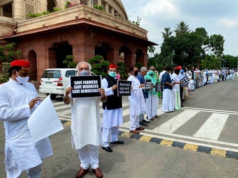MPs of opposition parties hold placards of 'Save Farmers' & 'Save Farmers, Save Workers, Save Democracy' during a protest over farm bills, at Parliament premises in New Delhi on Wednesday. 