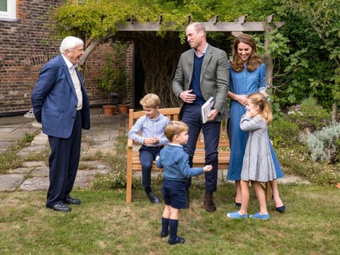 A handout photo released by Britain's Prince William and Cathrine, Duchess of Cambridge, Prince George (seated), Princess Charlotte and Prince Louis with David Attenborough after Prince William and David Attenborough attended an outdoor screening of the upcoming Attenborough's feature film, in the gardens of Kensington Palace, in London, Britain, September 24, 2020.