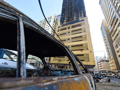Burnt cars and debris outside the Abbco Tower in Al Nahda, Sharjah, a day after the fire broke out in May.
