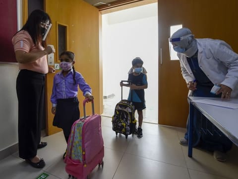 Students arrive at Al Wahda Private School in Sharjah, which reopened on Sunday.