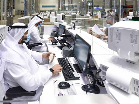 Immigration officers at Terminal 3, Dubai International Airport as Dubai reopens international travel for tourists and residents 