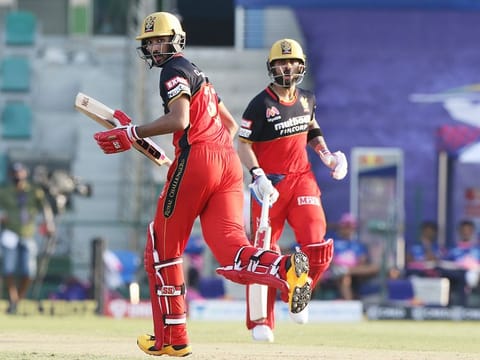 Virat Kohli of Royal Challengers Bangalore and Devdutt Padikkal cross over for a single during their match against Rajasthan Royals in Abu Dhabi on Saturday.  