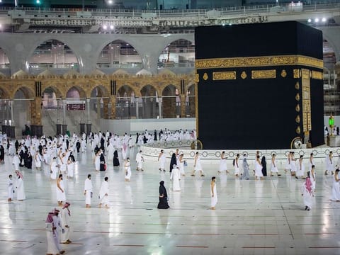 File image: Pilgrims practice social distancing while praying around the Kaaba.