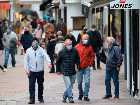 People wearing masks in Saint Jean de Luz, southwestern France.  French President Emmanuel Macron announced a nationwide four-week lockdown, shutting down schools and business, in the latest sign that Europe is yet again losing control of the pandemic.